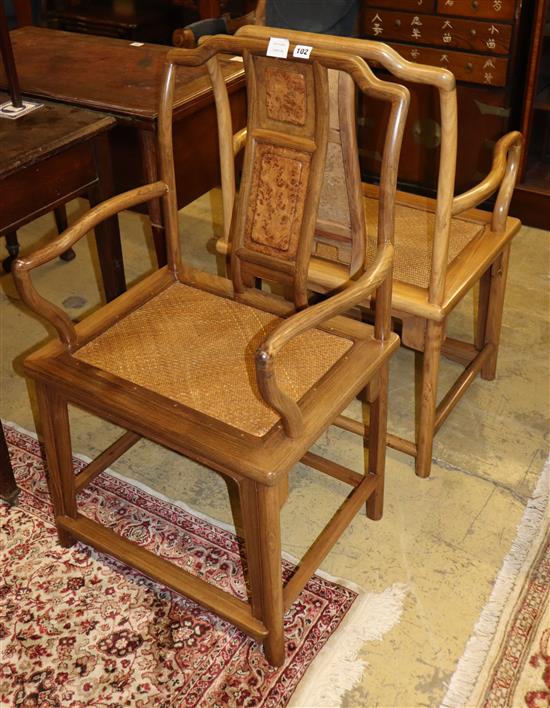 A pair of Chinese Ming style hardwood elbow chairs, with caned seats, W.54cm, D.48cm, H.95cm